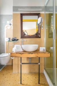 a bathroom with a sink and a mirror and a toilet at Cinqueteste Luxury Home in Venice