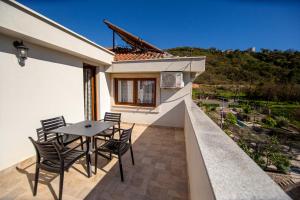 a patio with a table and chairs on a balcony at Hotel Opera Jaz in Budva
