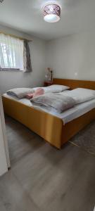 a bedroom with a large bed with white sheets at Begova kuća-Velika Kladuša in Velika Kladuša