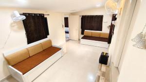 a living room with a couch and two beds at The Wai Hills MTDC Approved in Wai +87 photos