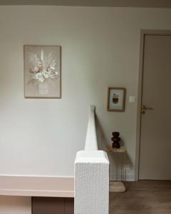 a white room with a picture of a flower on the wall at Le Moulin de Blanchelande in Neufmesnil +6 photos