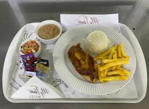 a tray of food with meat and french fries and rice at Motel My Flowers 4 in São Paulo