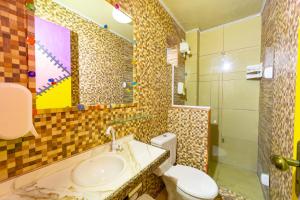 a bathroom with a sink and a toilet and a shower at Pousada das Galinhas in Porto De Galinhas
