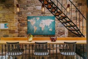 a map of the world hanging on a brick wall at Chios City Inn in Chios