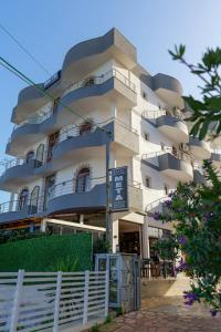 a large building with balconies on the side of it at Hotel Meta Ksamil in Ksamil