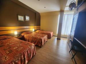 Postel nebo postele na pokoji v ubytování Hotel El Brujo Centro Histórico