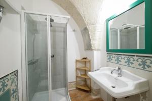 a bathroom with a sink and a shower at Masseria Borgo Santuri in Ostuni