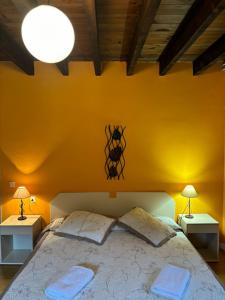 a bedroom with a large bed with yellow walls at Zubietako Ostatua in Zubieta
