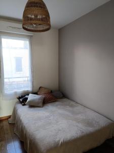 a bedroom with a bed and a large window at Maison Stade de France in Saint-Denis