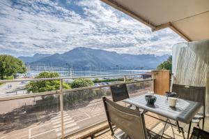 a balcony with a table and chairs and a view at The Lake Terrace in Annecy