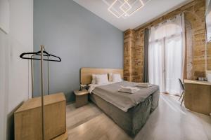 a bedroom with a large bed and a window at Chios City Inn in Chios