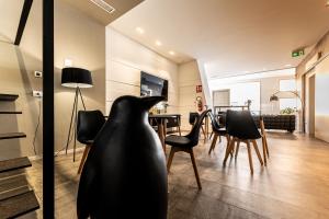 a living room with a black vase on the floor at Neko Boutique Hotel in Cagliari