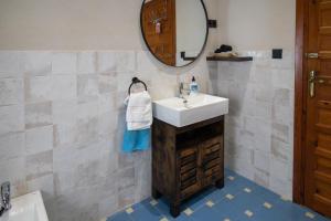 a bathroom with a sink and a mirror at La Casa de la Lela in Setenil +44 photos