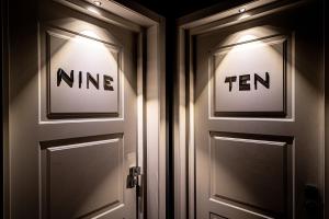 two doors with the words mine and ten on them at Neko Boutique Hotel in Cagliari