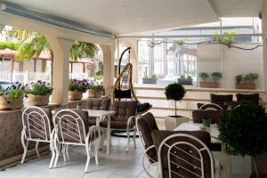a restaurant with chairs and tables on a patio at HOTEL PAVLOS in Paralia Katerinis