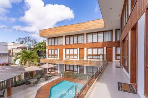 an indoor courtyard of a building with a swimming pool at CPR - Apartamentos a 200m da praia com Piscina in Marau