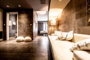 a living room with a couch in a room at Neko Boutique Hotel in Cagliari