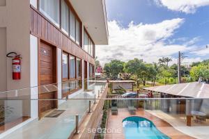 a view of a building with a swimming pool at CPR - Apartamentos a 200m da praia com Piscina in Marau