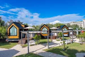 a group of tiny houses with a playground at Efe Tiny House in Serik