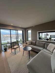 a living room with a couch and a table at Oppheimhamna 10c in Bø +8 photos