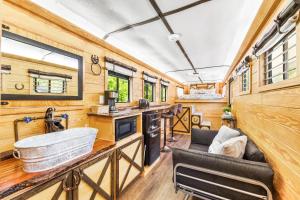 a kitchen with a sink and a tub in a tiny house at Wild Horse Retreat in Conway