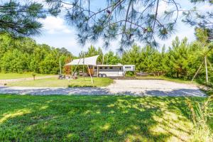 an rv parked in a field with a tent at Wild Horse Retreat in Conway