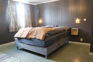 a bedroom with a bed in a room with a window at Vareid Panorama Lofoten Vareidstua in Vareid