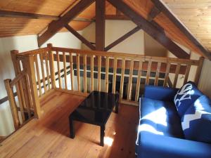 Una sala de estar con un sofá azul y una mesa. en Mas de Rossignol, en Vailhourles 25 fotos más