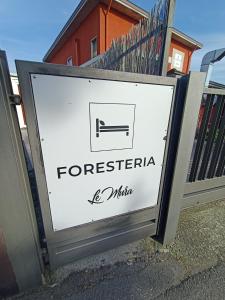 um sinal em frente a uma casa em LE MURA Foresteria em Grassobbio