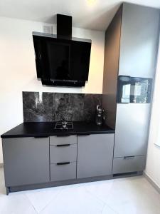 a kitchen with a tv on top of a refrigerator at Apartament przy Rynku Świętego Antoniego in Wrocław +19 photos