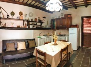 a kitchen and dining room with a table and a couch at Appartamenti Fior Di Loto in Trapani