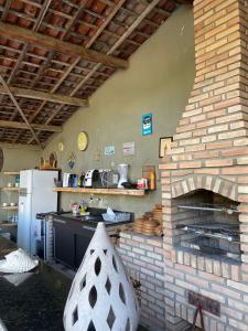 uma cozinha com um forno de tijolos num quarto em Chalé Céu estrelado em Caruaru