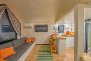 a living room with a couch and a kitchen at Efe Tiny House in Serik