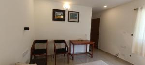 a room with a small table and two chairs at Oriole Homestay in Thekkady