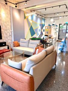 a living room with two couches and a table at Sunshine B&B in Kangle