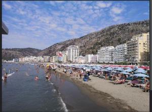 un grupo de personas en una playa con sombrillas en TheCozyView1, en Lezhë