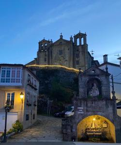 an old building on top of a hill with a building at CASA do CAMPO in Lestrove