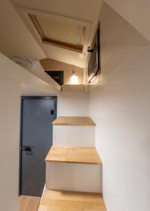a staircase in a house with a blue door at Efe Tiny House in Serik