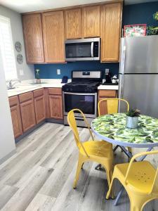 a kitchen with a table and chairs and a refrigerator at Pacific Plaza Resort in Oceano