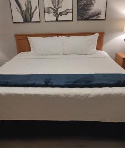 a bed with a blue and white blanket on it at Pacific Plaza Resort in Oceano