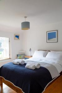 a bedroom with a bed with towels on it at Charlestown cottage, Woodburner, Gardens & Parking in Charlestown