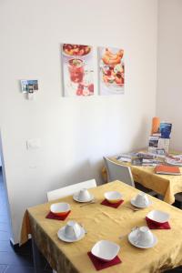 two tables with plates and bowls on top of them at B&B Fanzago in Bergamo