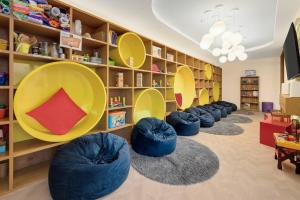a library with blue bean bags and bookshelves at Wyndham Grand Cancun All Inclusive Resort & Villas in Cancún