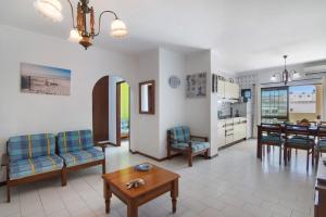 a living room with a couch and a table at Family Beach View - Praia da Rocha in Portimão