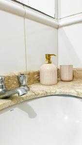 a bathroom counter with a sink and a faucet at Casa Maresias Canto do mar - 50m da praia in Maresias