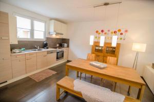 a kitchen with a wooden table and a dining room at Bianca's Kaiserstuhl in Ihringen +10 photos