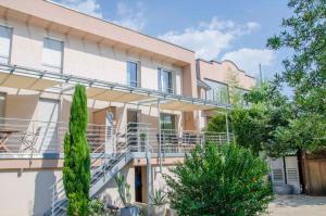 a building with balconies and trees in front of it at Bianca's Kaiserstuhl in Ihringen