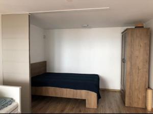 a small bedroom with a bed and a mirror at Studio with a sea view in Balchik