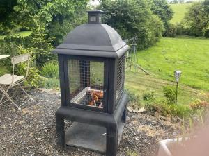 a black lantern with a fire in a yard at Lovely shepherds hut in Cornwall in Camelford