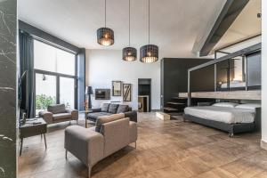 a bedroom with a bunk bed and a living room at Neko Boutique Hotel in Cagliari